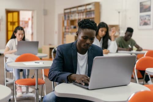 Student working on a laptop in a classroom