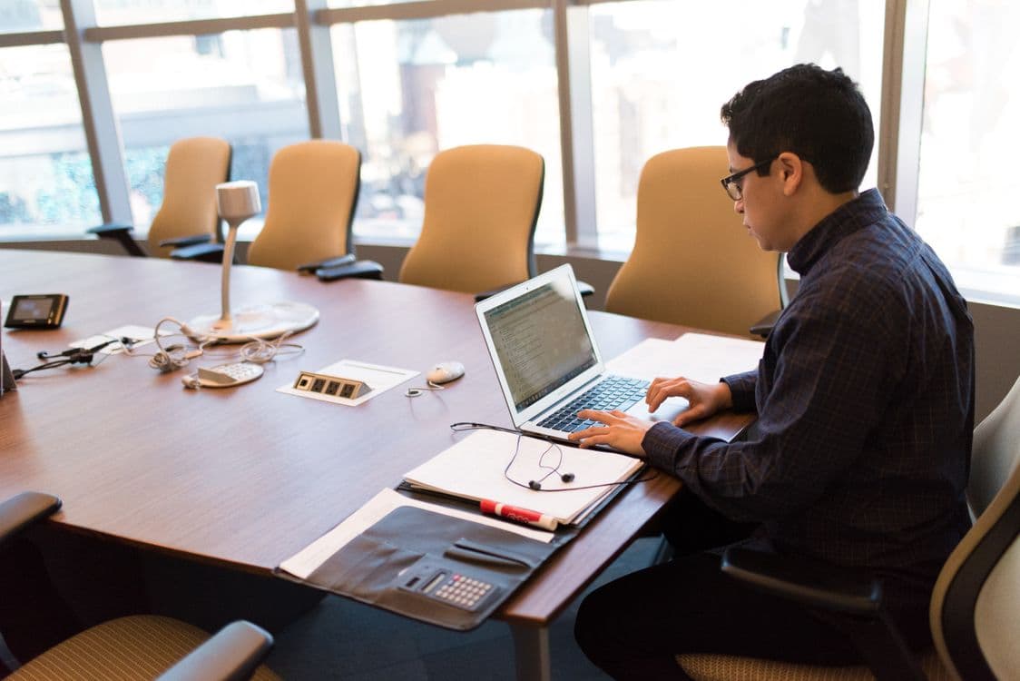 Professional working at a desk with a laptop