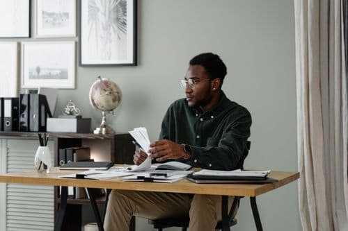 Adult learner studying documents at a desk